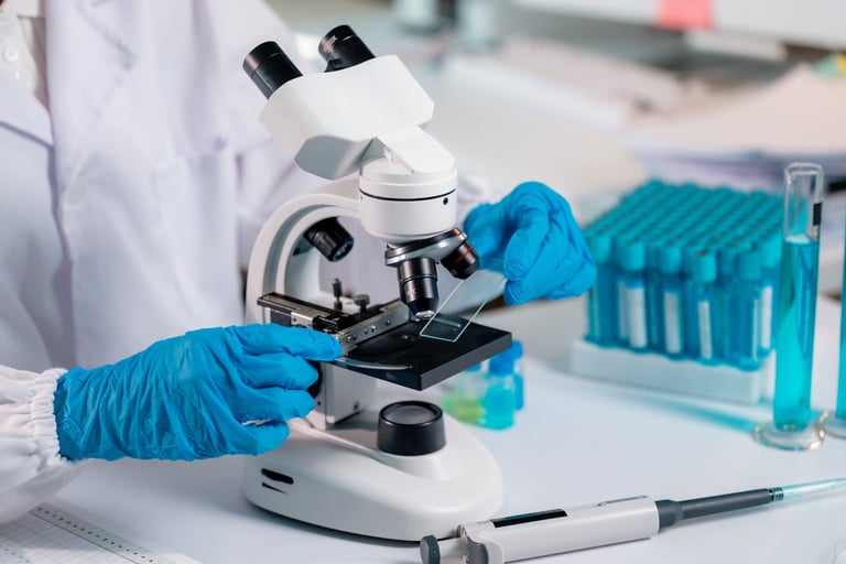Scientist placing glass slide on microscope