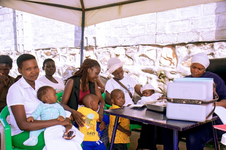 Healthcare workers providing medical services to children and adults at an outdoor clinic under a tent structure