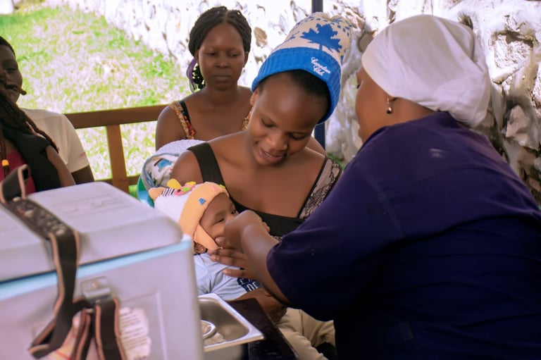 Healthcare worker administering vaccination to a child while mother looks on during a community health outreach program